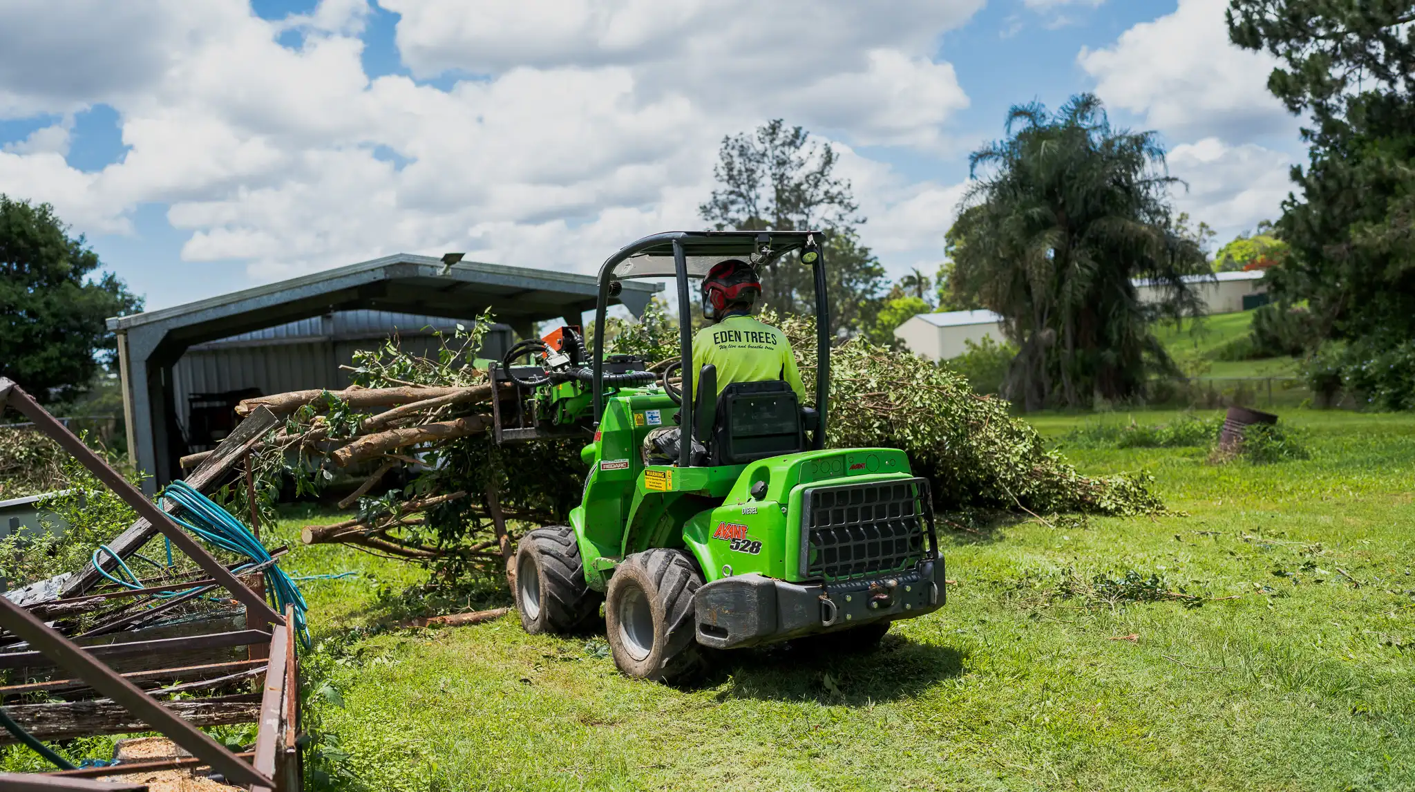 Eden Trees arboriculture services removing trees with a small machine near Logan Brisbane